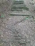 Pískovcové stupně místy doplňuje cihlové štětování.
