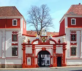 Barevná fotografie vstupního portálu se sochařskou výzdobou v Budyšíně