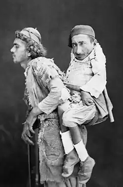 Slepec nese na zádech postiženého; Levanta, 1889