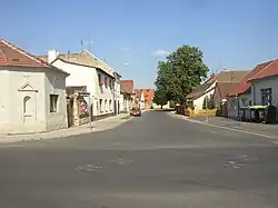 Pohled od křižovatky hlavních ulic k východu, vlevo výklenková kaplička v nároží domu čp. 30
