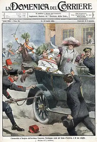 Barevná historická ilustrace na obálce časopisu zobrazuje atentát na Františka Ferdinanda d'Este a jeho ženu. V centru děje je manželský pár v otevřeném automobilu. Ferdinand má na sobě bílou uniformu s vyznamenáními, jeho žena má široký klobouk a šedé elegantní šaty. Okolo nich jsou vojáci a v popředí atentátník, který míří revolverem. Scéna působí chaoticky a napjatě, s vojáky, kteří se snaží zasáhnout, a vystrašenými obličeji. V pozadí je vidět městský dům s okny, z nichž jedno je otevřené a na scénu z něj hledí člověk.