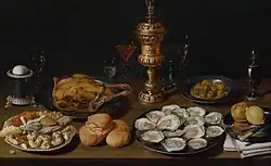 Obraz Zátiší s kapounem, ústřicemi, chlebem, pečivem, různými sklenicemi a kalichem, David Rijckaert, 1650
