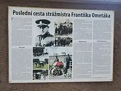 Informační tabulka na hřbitovní zdi v Mutějovicích připomínající F. Ometáka a popisující události na Požárech