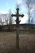Kamenný kříž u silnice z vesnice
