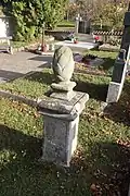 Overview_of_round_grave_sculpture_at_cemetery_in_Biskupice-Pulkov,_Třebíč_District.jpg