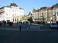 Pohled na náměstí z konce Čopovy ulice. Socha France Prešerena stojí v centru a budova nalevo je hlavní lékárna