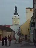 Městská věž z Divadelní uličky, vpravo budovy Spolku svatého Vojtěcha