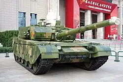 digitally camouflaged tank in front of a museum
